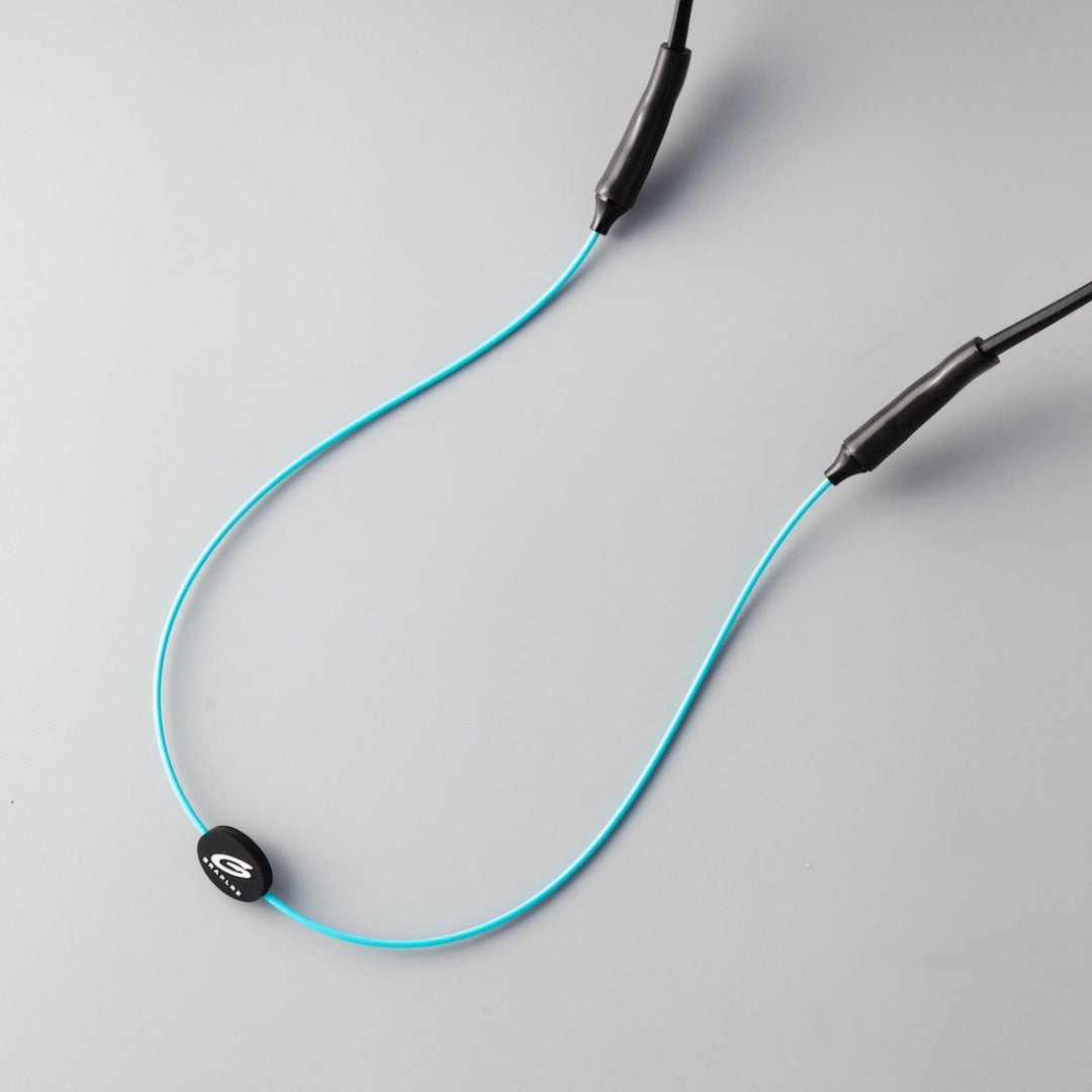 Close up of aqua GRAPLRZ sunglass retainers on grey background