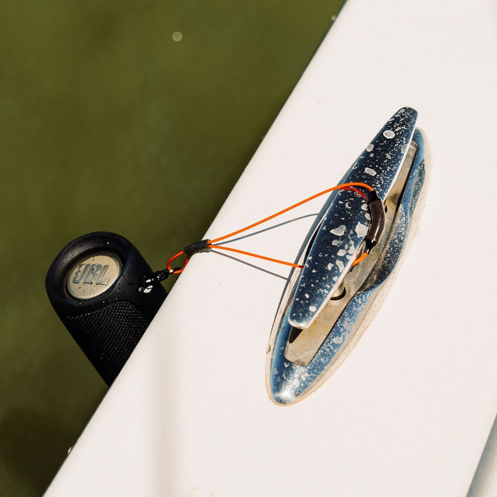 Orange GRAPLRZ Verza Mini Utility Lanyard wrapped around docking pole and boat cleat