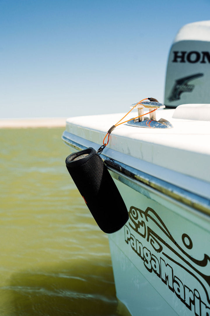 Orange GRAPLRZ Verza Mini Utility Lanyard clipped to item hanging from cleat over the edge of a boat