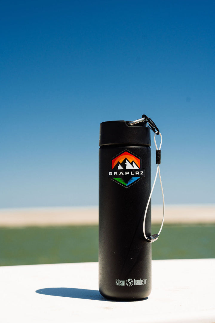 Black water bottle with multicolored GRAPLRZ sticker and white Verza Mini Utility Lanyard