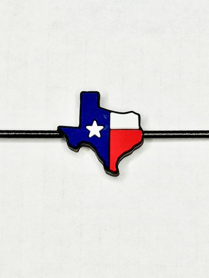 Close up of Texas charm with red, white, and blue flag design on black GRAPLRZ sunglass retainers