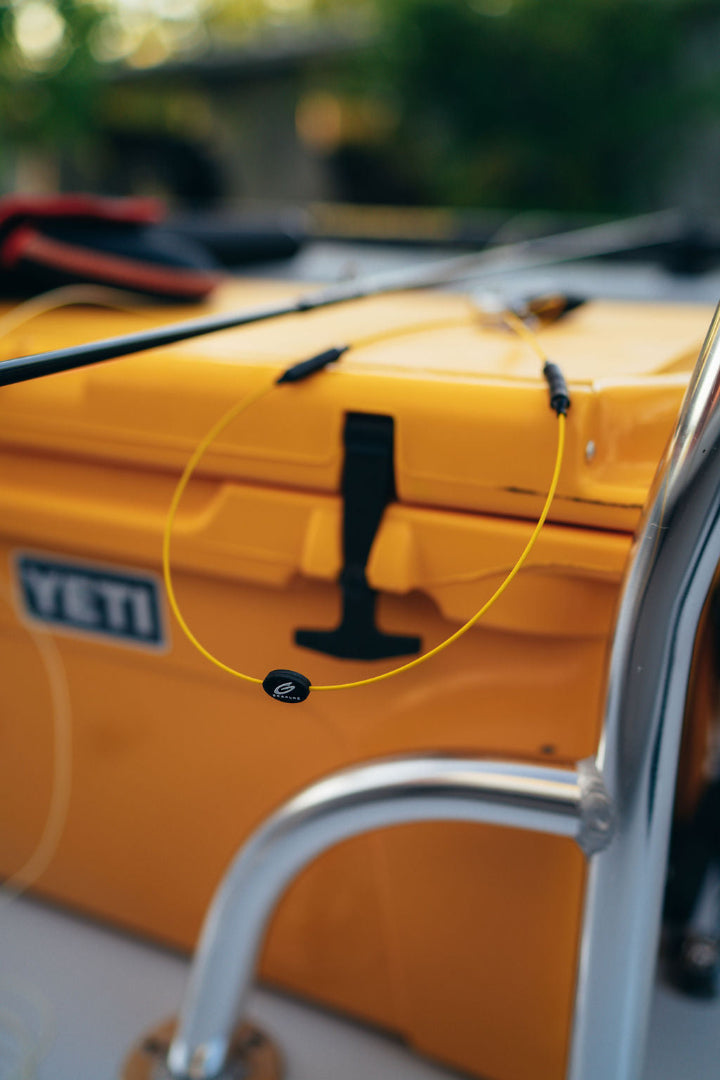 Yellow GRAPLRZ Verza Mini Utility Lanyard on top of a yellow trunk